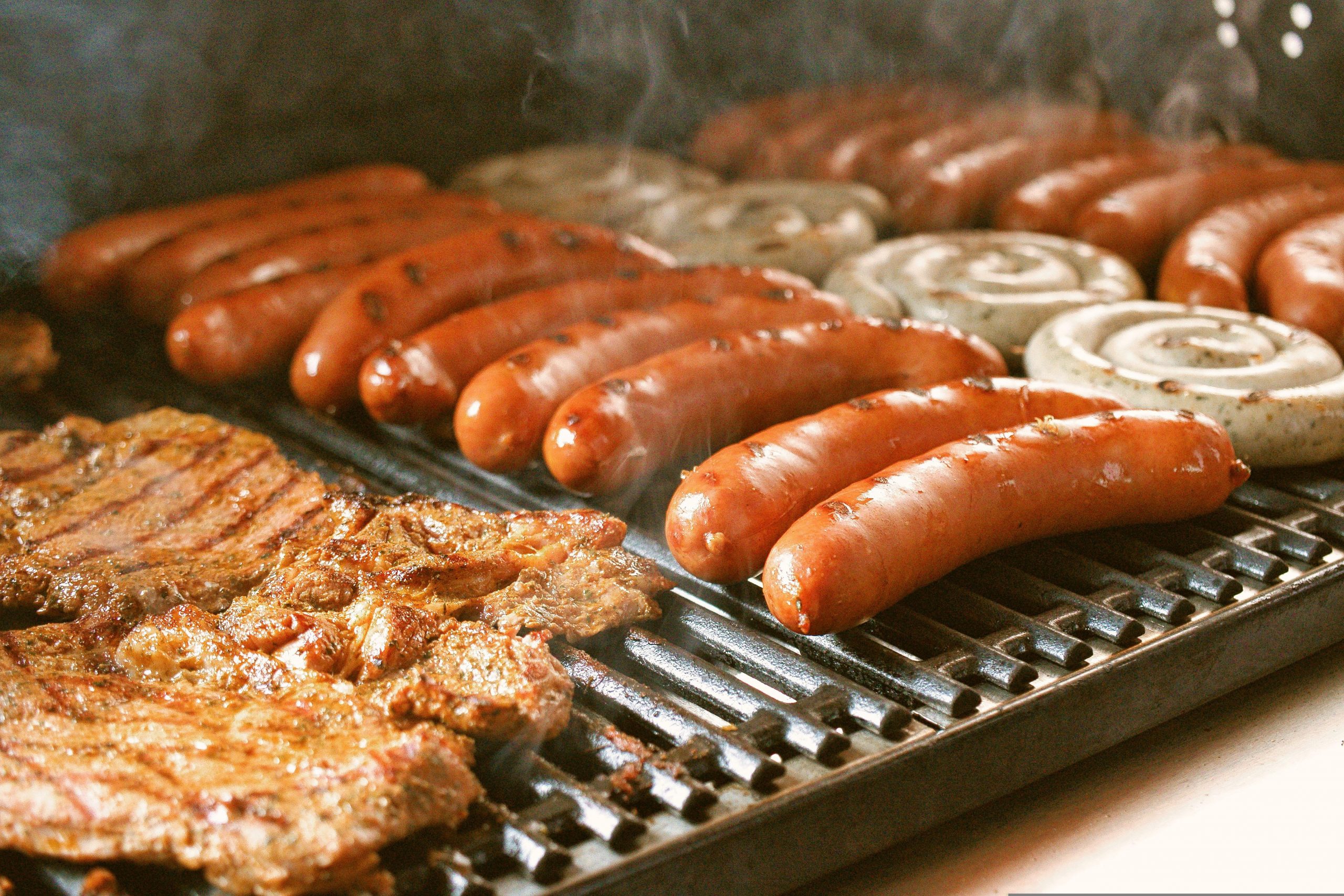 barbecue-6475700 A BBQ full of meat and sausages