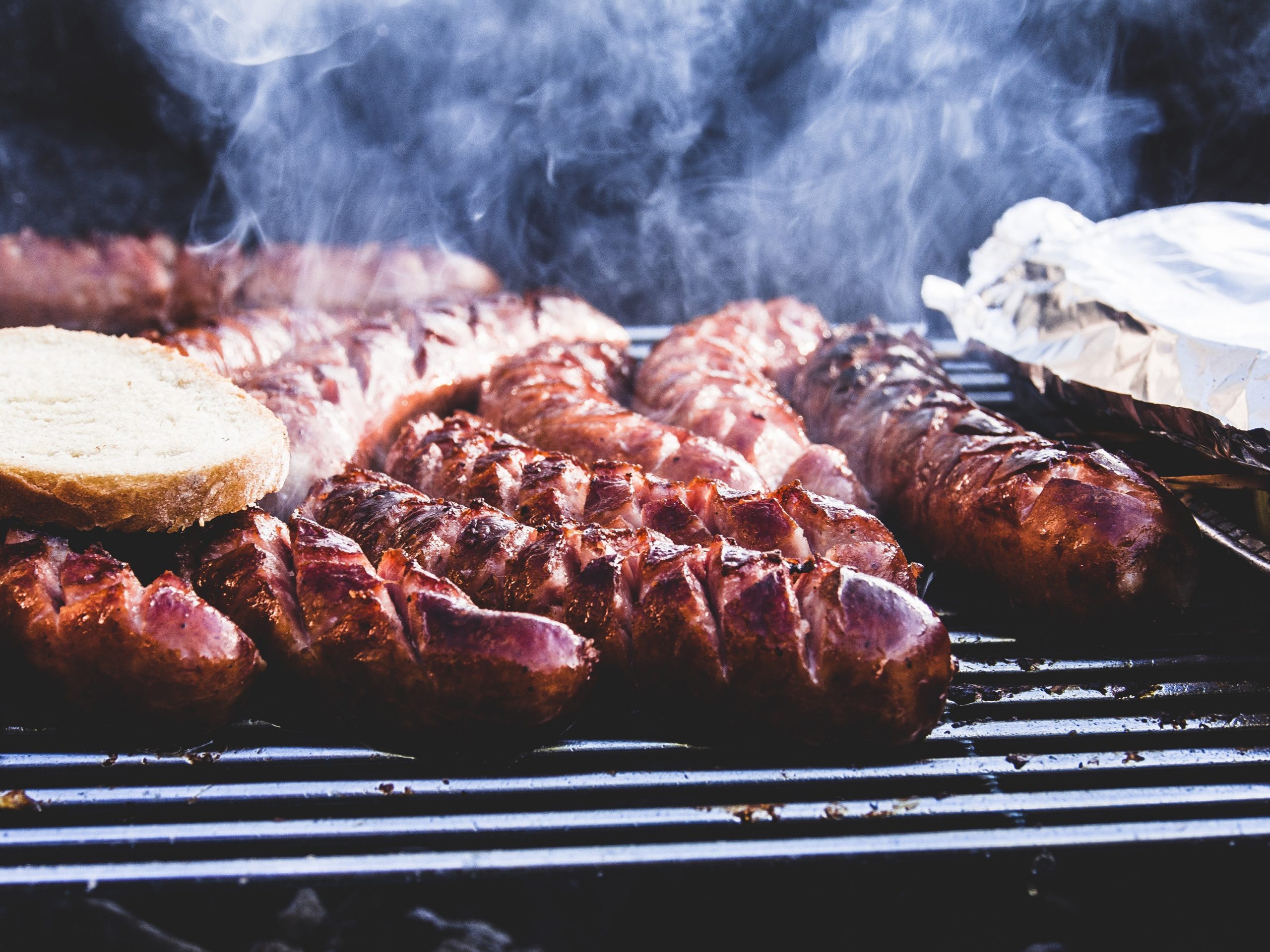 various sausages on a grill