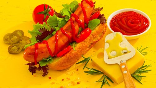 Cheese Frankfurter in a bund with ketchup and decoration