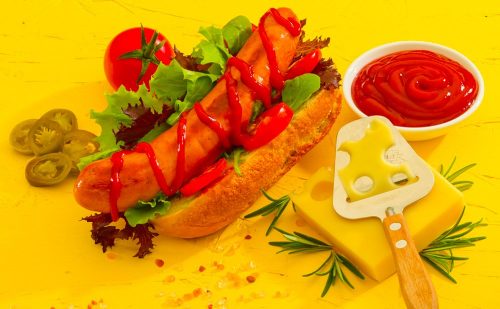Cheese Frankfurter in a bund with ketchup and decoration