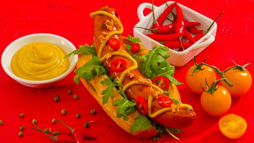 Chilli Beef Frankfurter in a bun with mustard and decoration