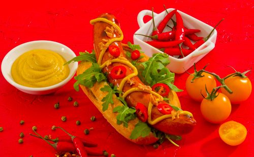 Chilli Beef Frankfurter in a bun with mustard and decoration