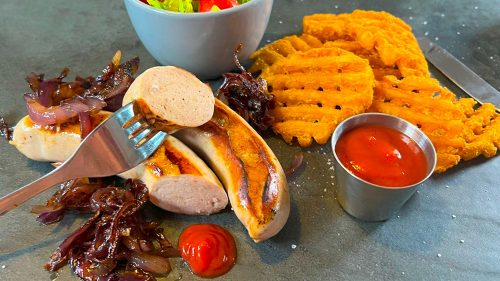 Bratwurst with potato waffles and salad