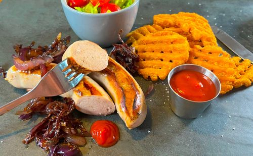 Bratwurst with potato waffles and salad