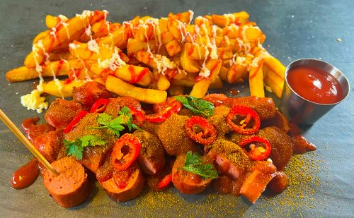 Chilli Beef Frankfurter Currywurst with chips and ketchup and mayonnaise