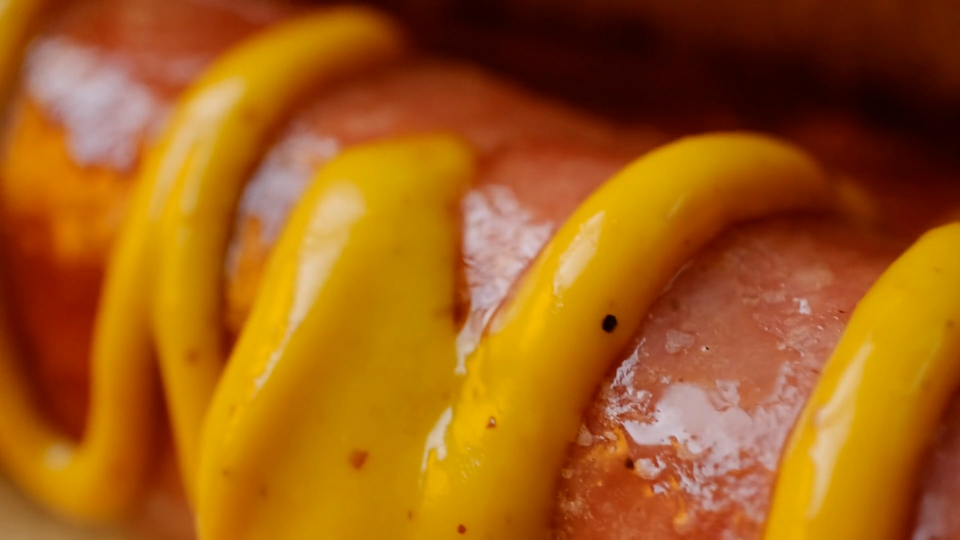 A Costco Hotdog label on a hotdog topped with mustard