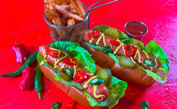 Loaded Chilli Beef Frankfurter hot dogs with fries, mustard, pickles, and chillies — spicy German frankfurters for BBQ caterers and retailers in the UK.