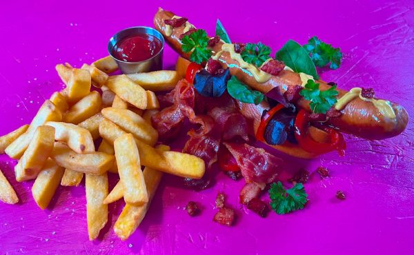 Bacon Frankfurter hotdog with crispy bacon, mustard, and fries by The Sausage Haüs.